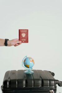 Passport, globe, and suitcase symbolize travel and adventure aspirations.